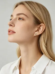 Elegant heart-shaped gold stud earring with pavé cubic zirconia worn by a blonde model.