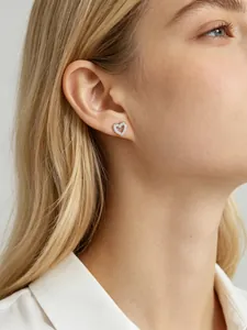 Close-up of heart-shaped s925 silver stud earring with micro-pave crystals on ear