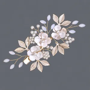 Elegant handmade bridal hair clip with white flowers pearls and gold leaves