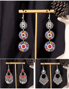Detail view of three bohemian earring styles featuring colorful patterns and tassels