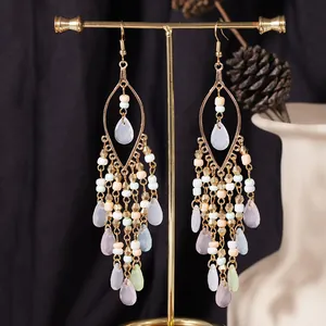 Bohemian gold long tassel earrings with colorful beads and water drop pendants.