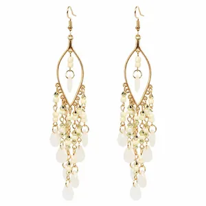 Elegant bohemian gold teardrop tassel earrings with white beads and vintage ethnic style