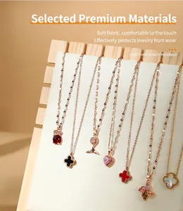 Detailed view of a multi-slot wooden necklace display stand with soft white lining