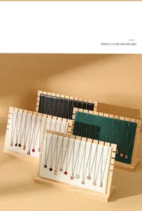 Multiple wooden jewelry display boards with colorful velvet linings for necklace organization