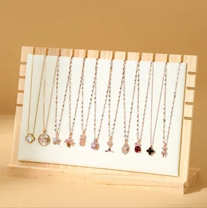 Professional wooden necklace display stand with twelve slots and soft cream padding.