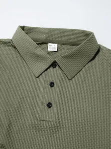 Detail of men's olive green textured polo shirt showing collar and buttons