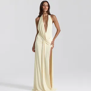 Sexy deep V-neck halter maxi dress with ruched details and high slit for summer party fashion.
