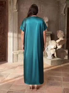 Back view of a luxurious emerald green satin maxi dress in a classical art studio