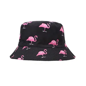 Close-up detail of the vibrant pink flamingo pattern on a black cotton bucket hat