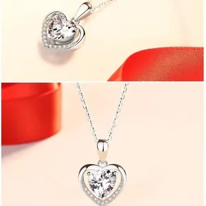 Detail of Heart of the Ocean necklace with clear heart-shaped stone and pave diamonds