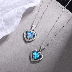 Close-up of elegant silver necklaces featuring heart-shaped blue crystal pendants
