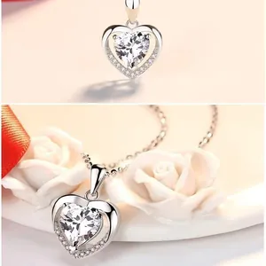 Detailed macro view of a silver heart pendant necklace with shimmering white stones