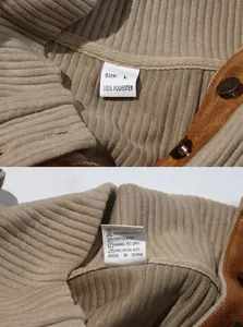 Detailaufnahme eines Herren-Strick-Sweatshirts mit Stehkragen und Pflegeetikett