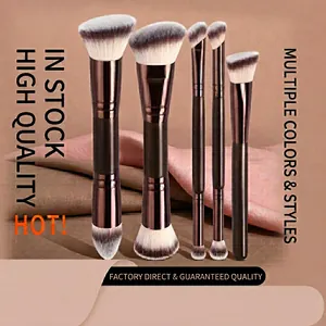 Detailed view of various brown professional makeup brushes with white-tipped bristles