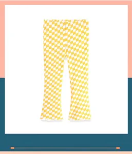 Detail of yellow checkered flare leggings for little girls with ruffled hem.