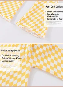 Detail of yellow checkered baby girl leggings showing lettuce edge hem and stitching
