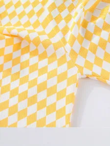 Detailed macro view of yellow and white checkered children leggings with ribbed fabric