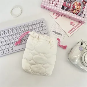 Close-up detail of soft quilted cloud-pattern camera pouch with pink drawstring cord