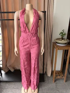 Close-up view of a stylish pink halter neck backless wide-leg jumpsuit with matching belt