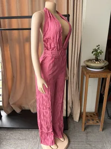 Side view of a sexy pink crinkled backless sleeveless wide-leg jumpsuit on mannequin