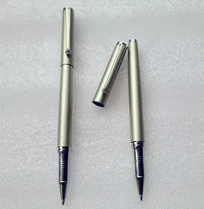 Detailed macro view of portable champagne gold metallic ballpoint pens with crystal accent