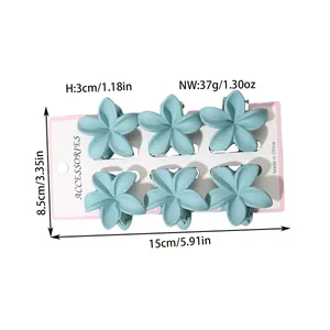 Detail showing dimensions of 6 light blue plumeria flower hair claw clips.