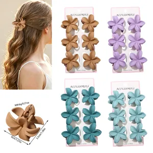 Detail view of matte frangipani flower hair claw clips with specific size measurements