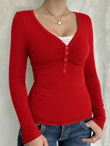 Close-up of red Y2K button-front long sleeve tee showing ribbed texture and buttons.