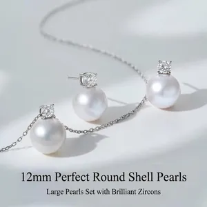 Macro detail of 12mm round shell pearl earrings with sparkling cubic zirconia