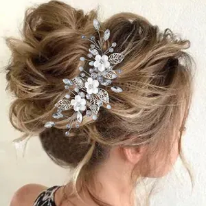 Bridal wedding hair accessory with silver leaves white flowers and crystals on updo