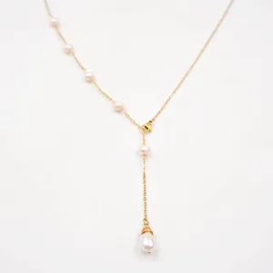 Close-up detail view of an adjustable gold-plated freshwater pearl long lariat necklace