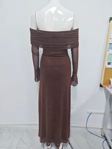 Detail of brown mesh glitter dress showing off-shoulder neckline and flared sleeves