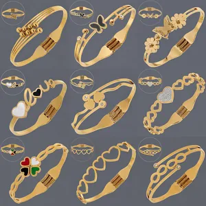 Set of 18K gold plated stainless steel open bangles with heart and butterfly motifs
