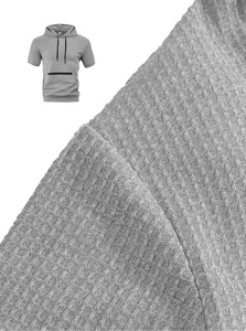 Macro detail of grey textured fabric on a men's casual hooded short sleeve t-shirt.