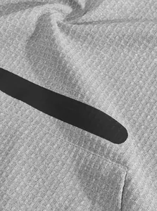 Close-up macro detail of grey heavyweight cotton T-shirt fabric with black accent