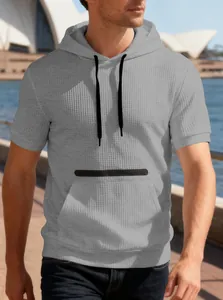 Casual men's grey hooded short sleeve t-shirt with waffle texture shown in an outdoor scene