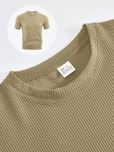 Close-up of khaki seersucker T-shirt fabric texture and interior size label.