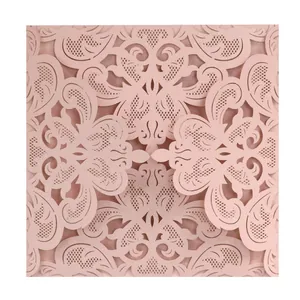 Elegant dusty pink laser-cut wedding invitation with intricate floral lace detail