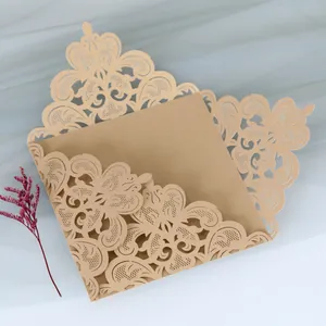 Intricate laser-cut lace detail on elegant gold wedding invitation card