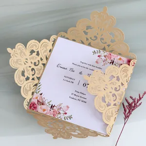Close-up detail of a premium gold laser-cut wedding invitation with floral card