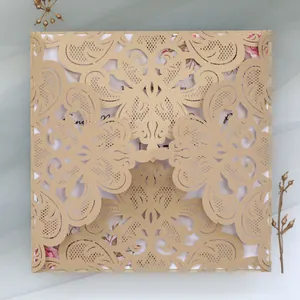 Detailed view of elegant gold laser-cut lace wedding invitation with floral pattern
