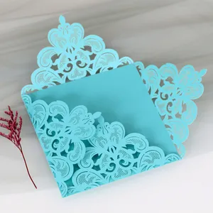 Detailed view of light blue laser-cut lace wedding invitation card with floral design