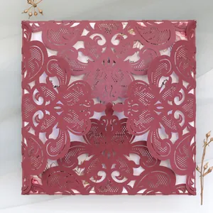 Intricate laser-cut burgundy lace wedding invitation card with floral inner sheet detail