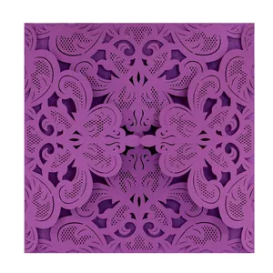 Intricate laser-cut purple lace pattern detail on elegant wedding invitation card.