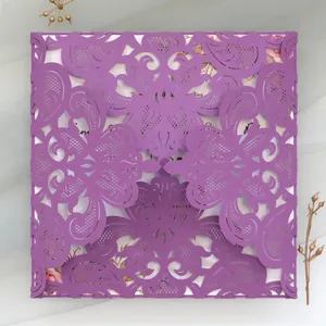 Detailed view of an elegant purple laser-cut lace wedding invitation card for events
