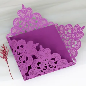 Intricate laser-cut purple wedding invitation card with elegant floral lace details