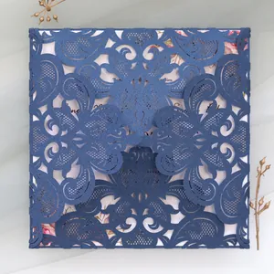 Detailed macro view of laser-cut wedding invitation in navy blue glitter cardstock