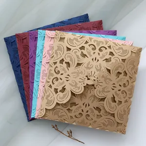 Variety of laser-cut lace wedding invitation envelopes in elegant shimmering colors