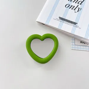 Close-up of green silicone heart-shaped phone socket with integrated mirror