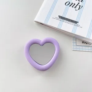 Detailed view of heart-shaped lavender silicone phone stand with integrated mirror